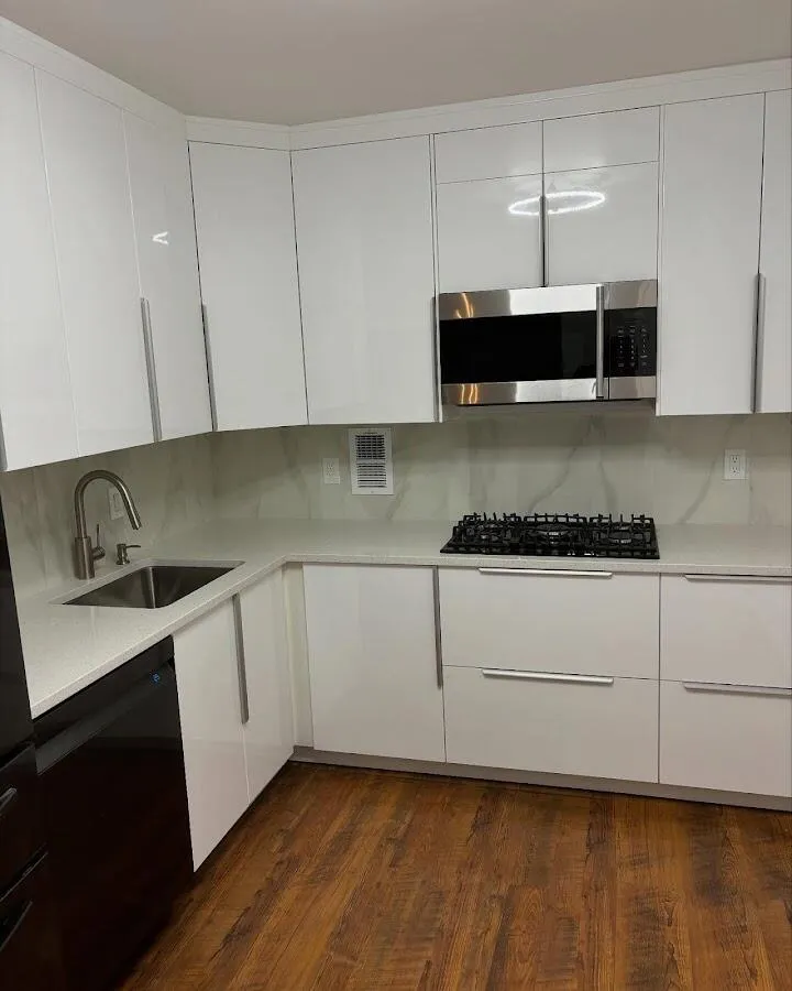 Restored kitchen with white cabinets after water damage in Astoria